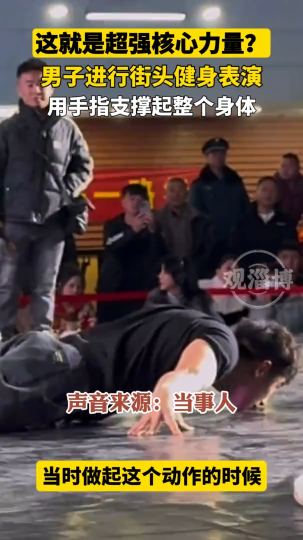 男子进行街头健身表演，用手指支撑起整个身体