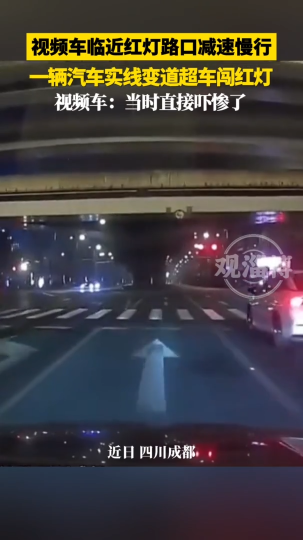 视频车临近红灯路口减速慢行，一辆汽车实线变道超车闯红灯